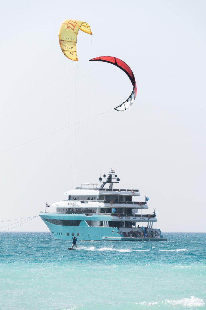 Kites flying in front of the yacht